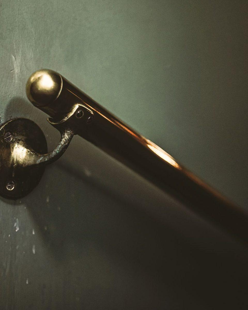 A brass lift surround